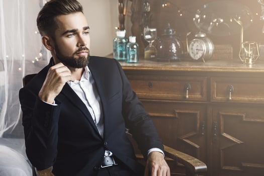 Handsome bearded man wearing black classic suit photo