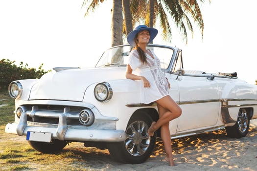 Happy young woman and retro convertible car photo