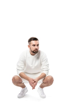 Handsome man wearing white sweatshirt and shorts on white background photo