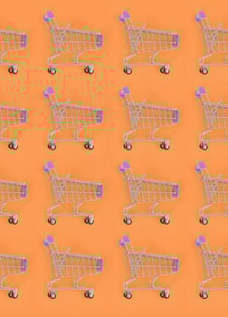 Shopping addiction, shopping lover or shopaholic concept. Many small empty shopping carts perform a pattern on a pastel colored paper background. Flat lay composition, top view photo