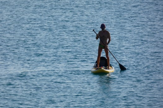 swimmer on vacation paddle surfing in the mediterranean sea photo