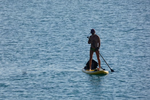 swimmer on vacation paddle surfing in the mediterranean sea photo