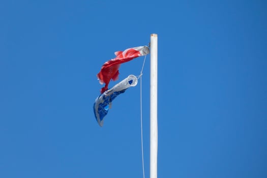 colorful flags under the blue sky fluttering in the wind photo
