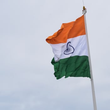 India flag flying high at Connaught Place with pride in blue sky, India flag fluttering, Indian Flag on Independence Day and Republic Day of India, tilt up shot, Waving Indian flag, Har Ghar Tiranga photo