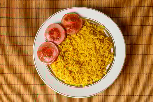 yellow rice on a plate with fried sausage photo