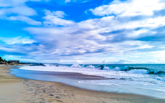 Beach sand blue water huge surfer waves Puerto Escondido Mexico. photo