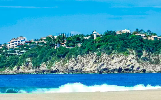 Beach sand blue water huge surfer waves Puerto Escondido Mexico. photo