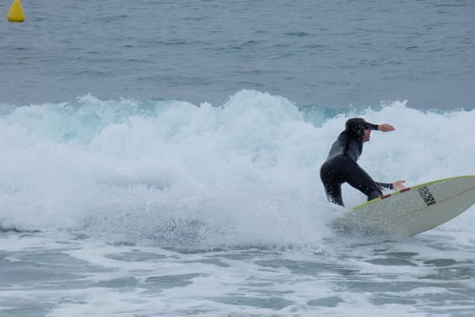 Surfers riding waves in a storm-tossed sea photo