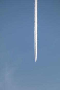 white wake of an airplane under the blue sky photo