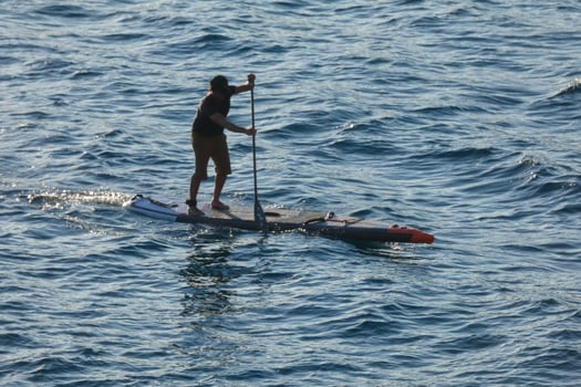 swimmer on vacation paddle surfing in the mediterranean sea photo