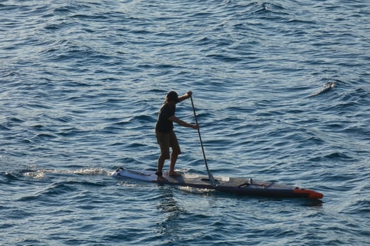 swimmer on vacation paddle surfing in the mediterranean sea photo