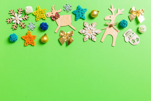 Top view of green background with New Year toys and decorations. Christmas time concept with copy space photo