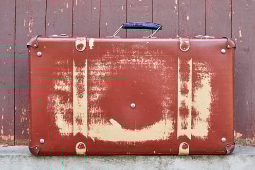 Vintage retro red suitcase, closeup. Old case photo
