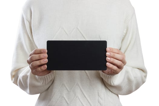 Girl holding an small blackboard isolated on white background photo