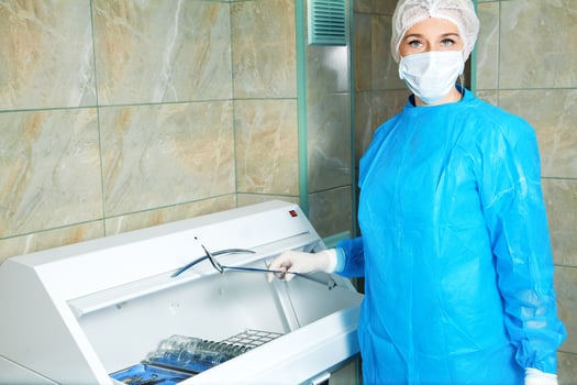 beautiful young woman doctor gets sterile items required for operation photo