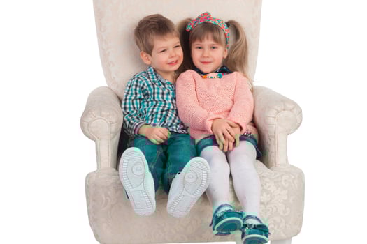 Children sit in a chair photo