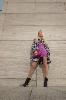 Blonde girl is posing in the city photo