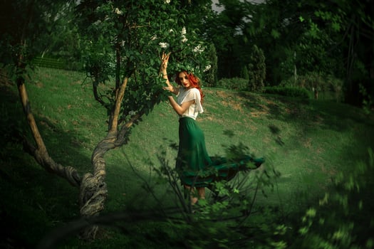 lady with wreath on head posing near tree photo