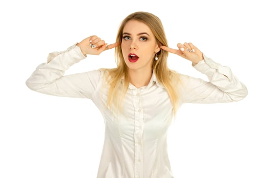 girl covers her ears with fingers from loud noises photo
