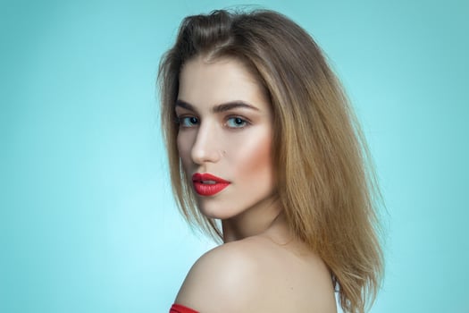 girl with red lips on blue background photo