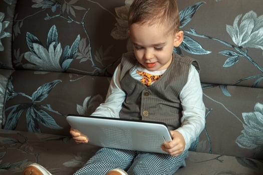 little boy in suit with tablet photo