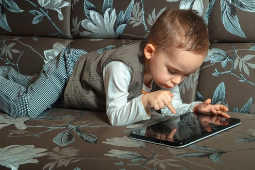 boy in elegant suit lying on a sofa photo
