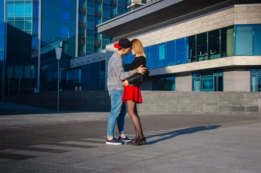 young couple outdoors hugging photo
