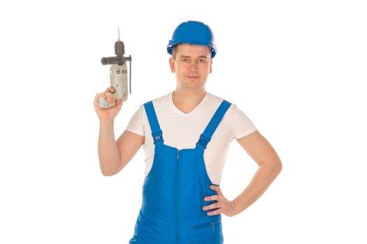 young man builder with drill in hands photo