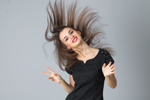 girl in black dress posing in studio photo