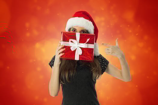 woman in santa hat with red gift photo