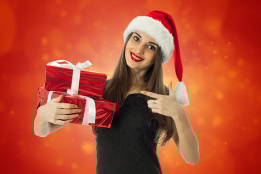 Happy woman in santa hat with red gift photo
