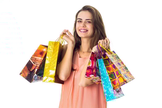 young cute girl keeps in two hands shopping bags photo
