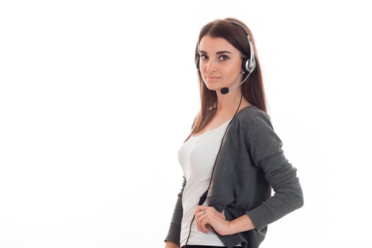 young attractive call office girl with headphones isolated on white background in studio photo