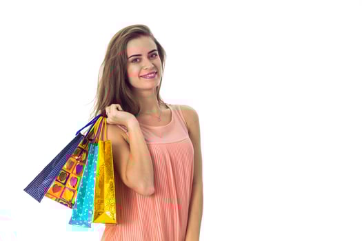 cute girl holds in one hand a lot of packages with purchases isolated on white background photo