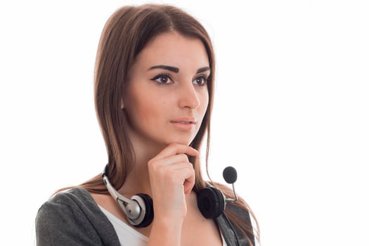 portrait of young pretty call center worker girl with headphones and microphone looking away isolated on white background photo