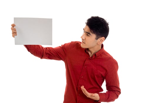 portrait of handsome young brunette male model with placard in hands isolated on white background photo