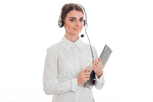 beautiful young brunette call office worker woman with headphones and microphone isolated on white background photo