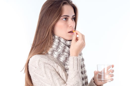 girl in  scarf worth sideways and drinking the Tablet is isolated on  white background photo