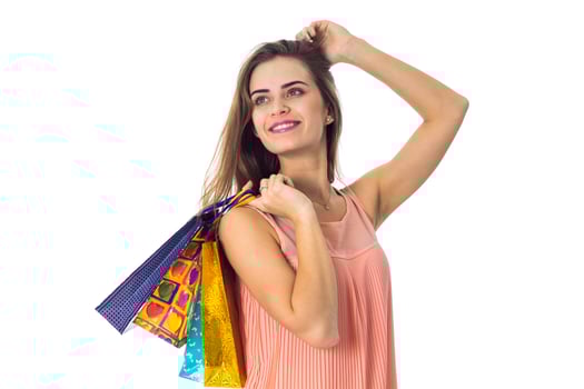 beautiful girl raised in hand many colored packages and rejoices isolated on white background photo