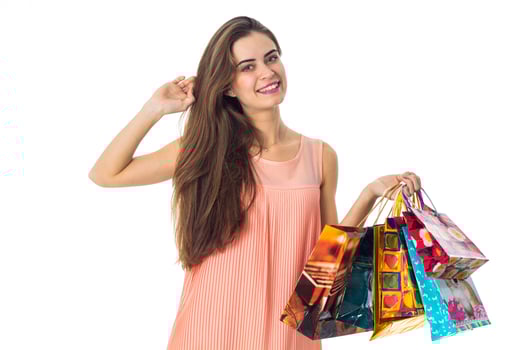 beautiful girl smiling and holding in his hand a lot of packages from stores isolated on white background photo