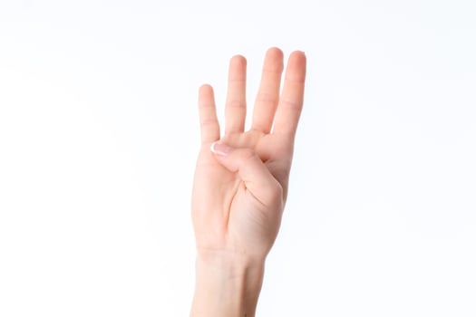 female hand stretched up and showing four fingers isolated on white background photo