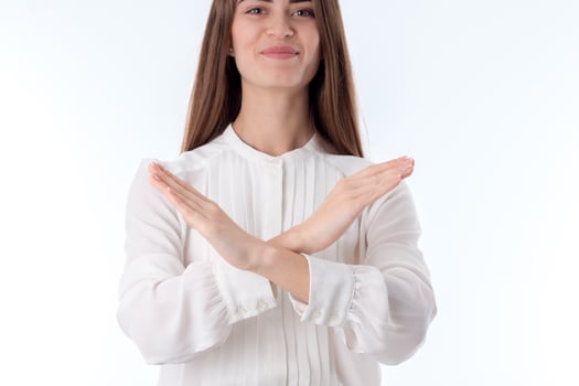 young girl in white shirt makes cross hands close-up photo