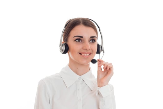 young girl in white shirt stands in headphones with microphone, smiling photo