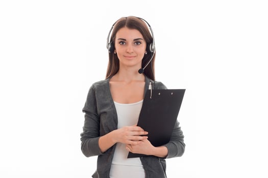 cute young girl looks right standing with headphones and holding a Tablet for securities photo