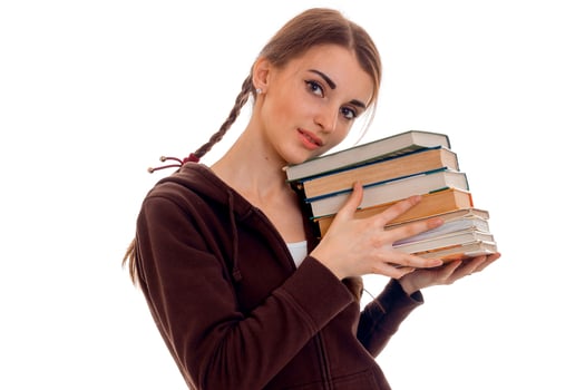 young girl-teen holds many books isolated on white background photo