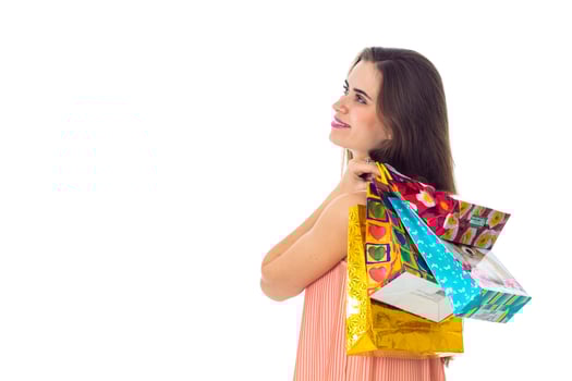 young girl turned sideways and keeps the shoulder beautiful bags isolated on white background photo