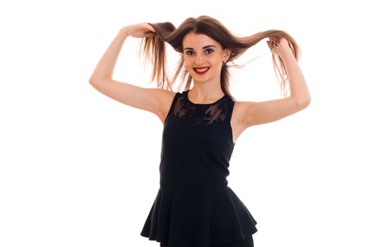 beautiful girl in black dress holding the hands of her hair and smiling photo