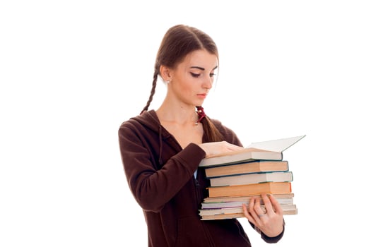 cute teen girl with pigtails holds many books photo