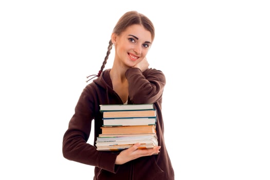 cute teen girl with pigtails smiling and holding a book in their hands photo