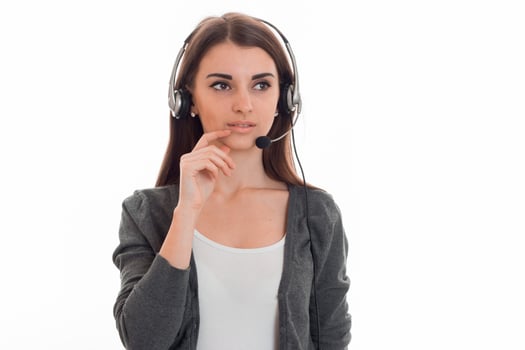 beauty young brunette business woman with headphones and microphone posing isolated on white background photo